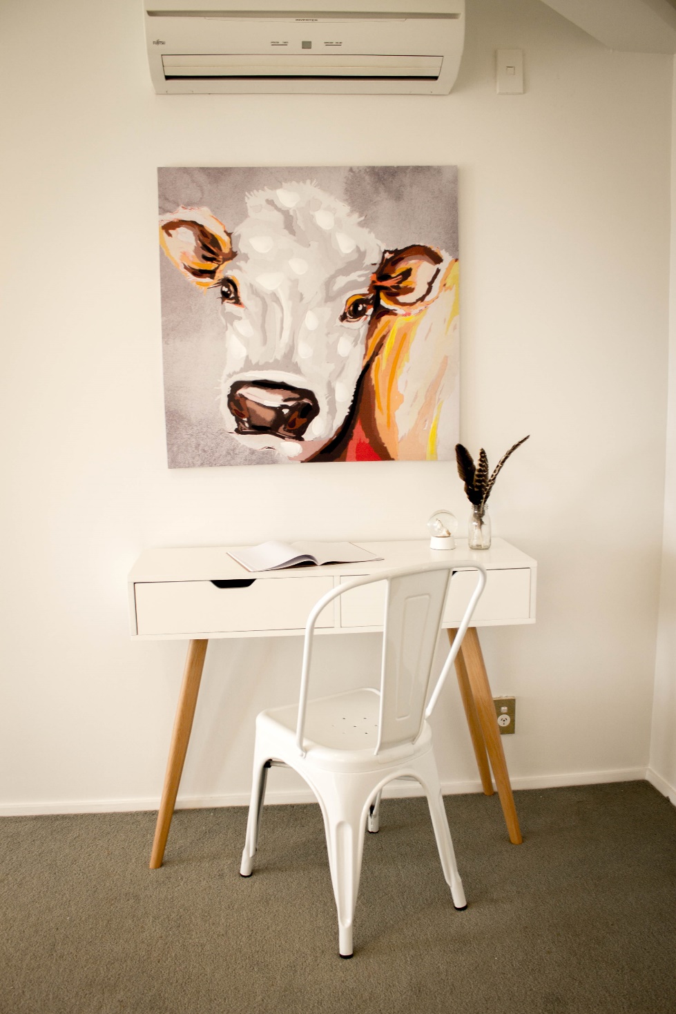 A painting of a cow in a Home Staged space